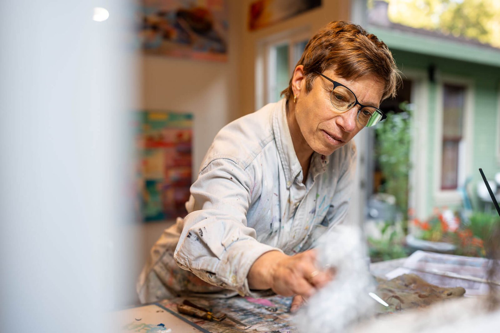 Artist and art therapist, Annie Danberg, mixing paint in her San Rafael, California, art studio