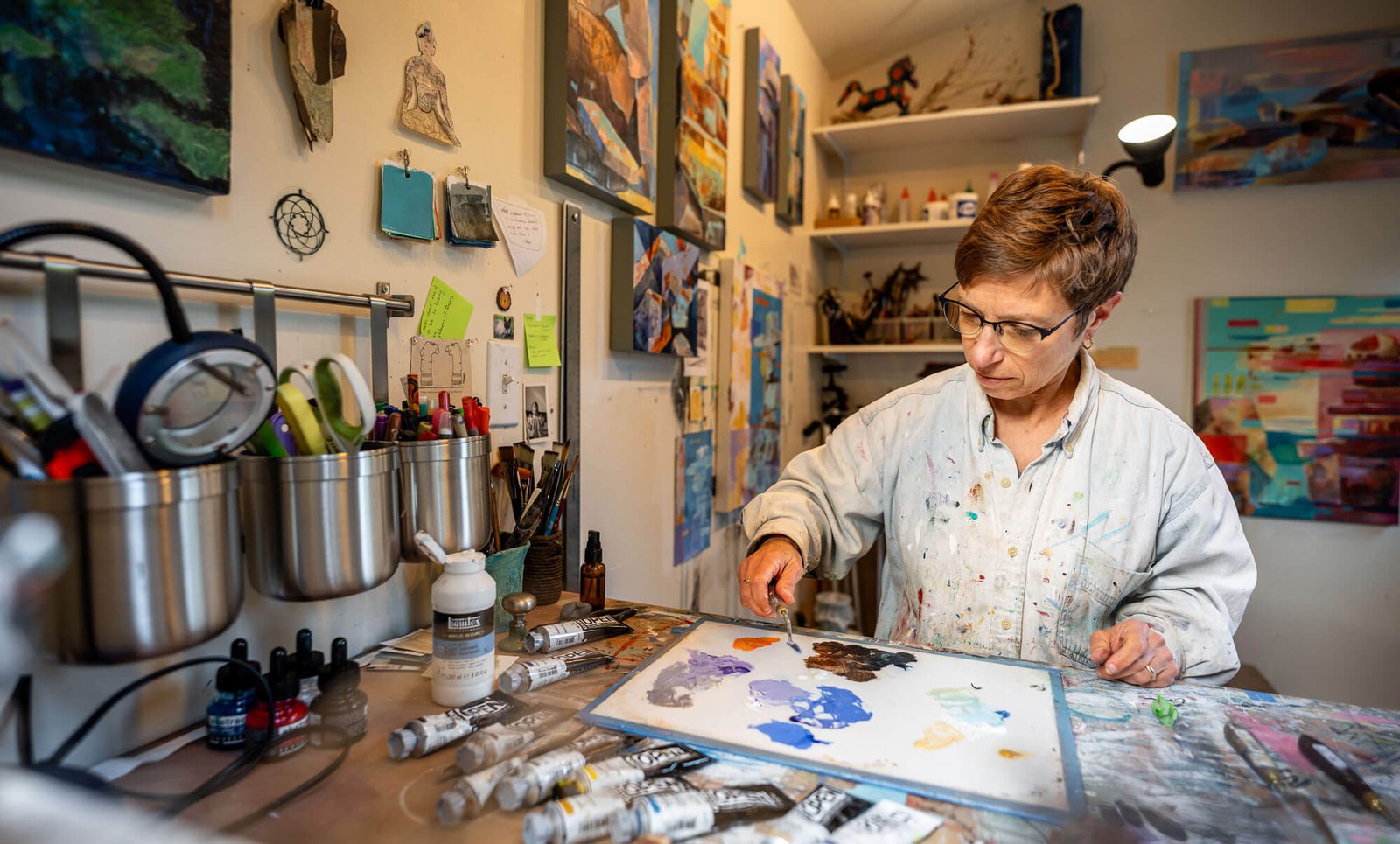 Artist and art therapist, Annie Danberg, mixing paint in her San Rafael, California, art studio